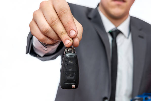 businessman holding car keys - alpha locksmith