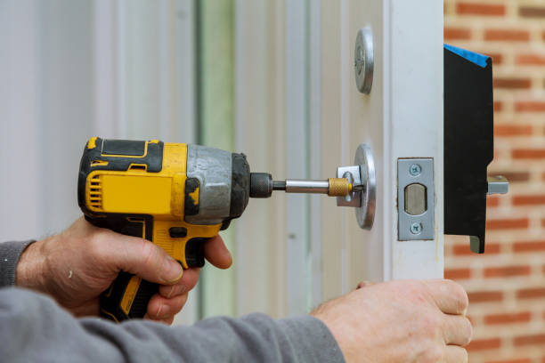 handyman using a screwdriver drill to installing lock - alpha locksmith
