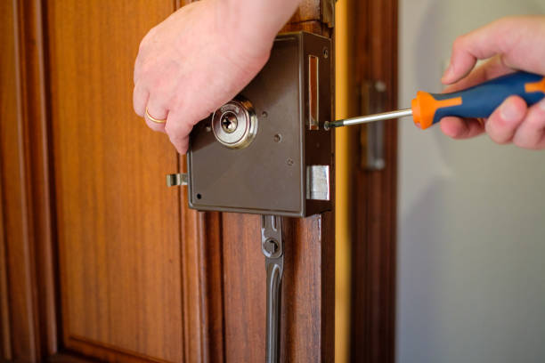 man changing a lock on the house door - alpha locksmith