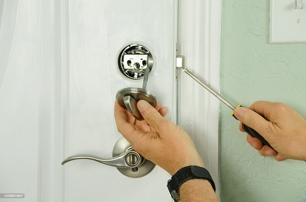 a man fixing the door lock